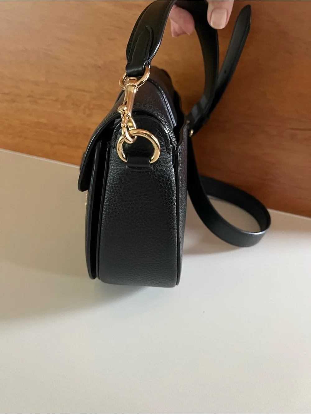 Coach Georgie crossbody saddle bag in black pebbled leather, gold tone hardware